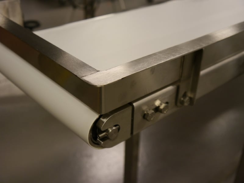 Stainless steel end stop on a stainless steel conveyor