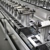 Pallets handing automotive parts on a conveyor