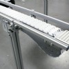 White roller transfers on a table top chain conveyor