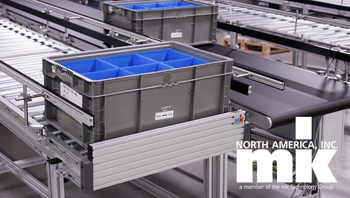 Gravity roller conveyor carrying plastic tote