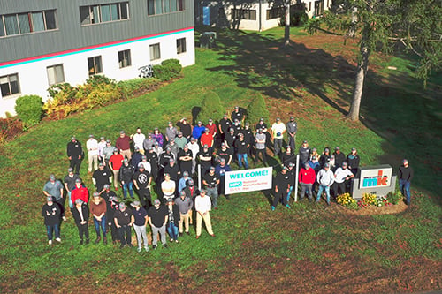 The employees of mk North America standing outside the building