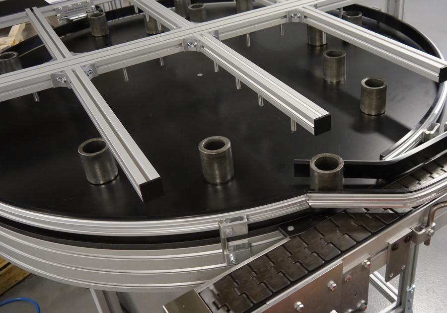 Parts being fed onto an accumulation table off a table top chain conveyor.