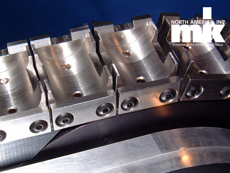close up of custom fixture on conveyor belt metal
