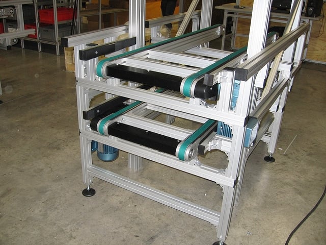 Two timing belt conveyors stacked on top of each other