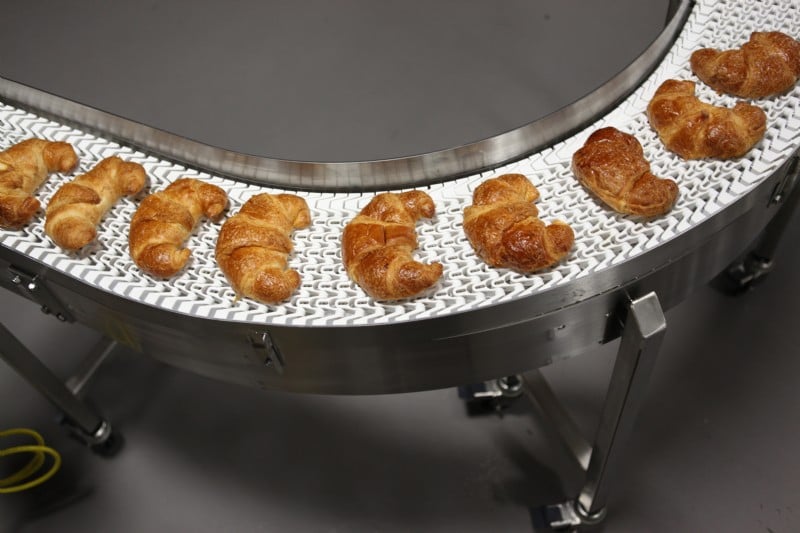 Hygienic conveyor carrying croissants.