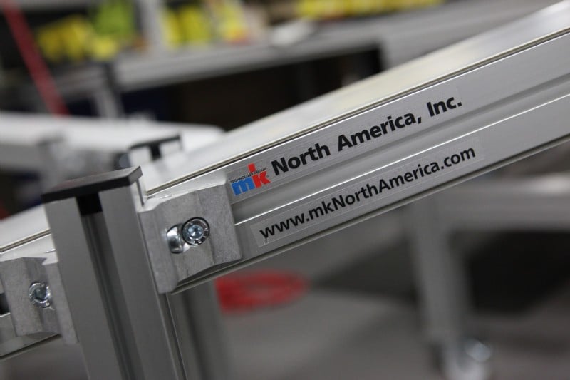 Aluminum frame conveyor with the mk North America logo