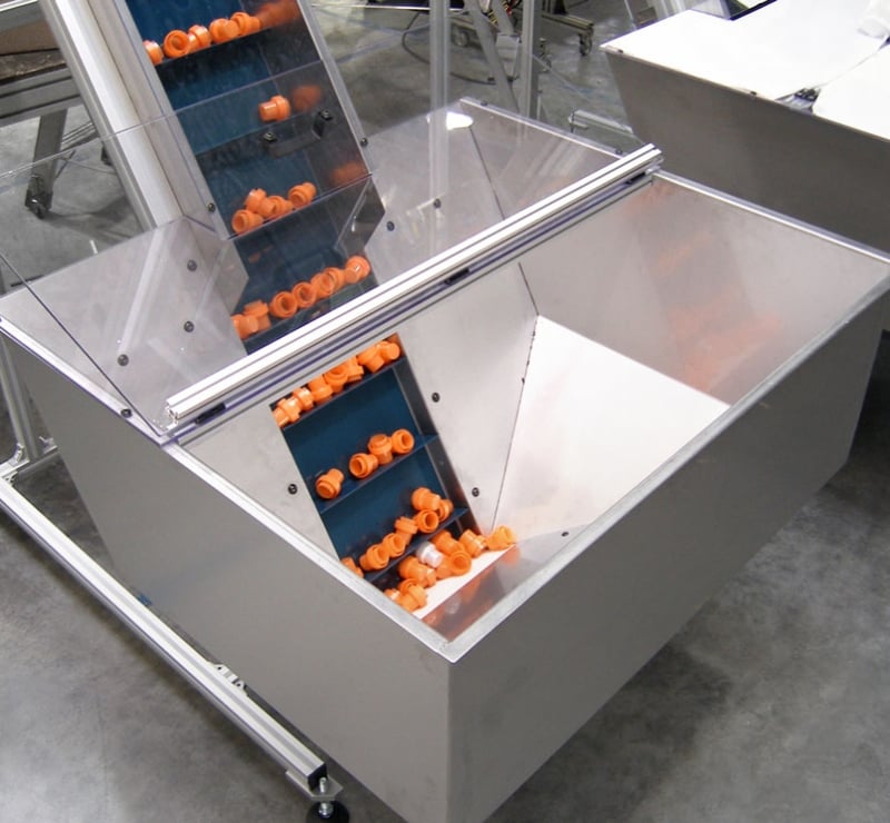 Cleated belt conveyor with hopper and orange parts