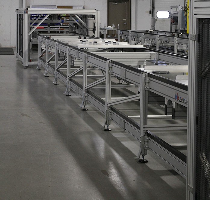 Over under conveyor system with vertical transfer units on each end