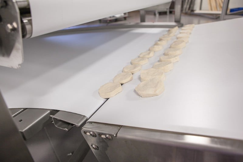 Conveyors, curved, handling biscuit dough over tight trasnfer