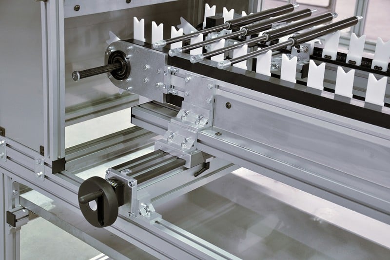 A chain fixtured chain conveyor with a width adjustment unit