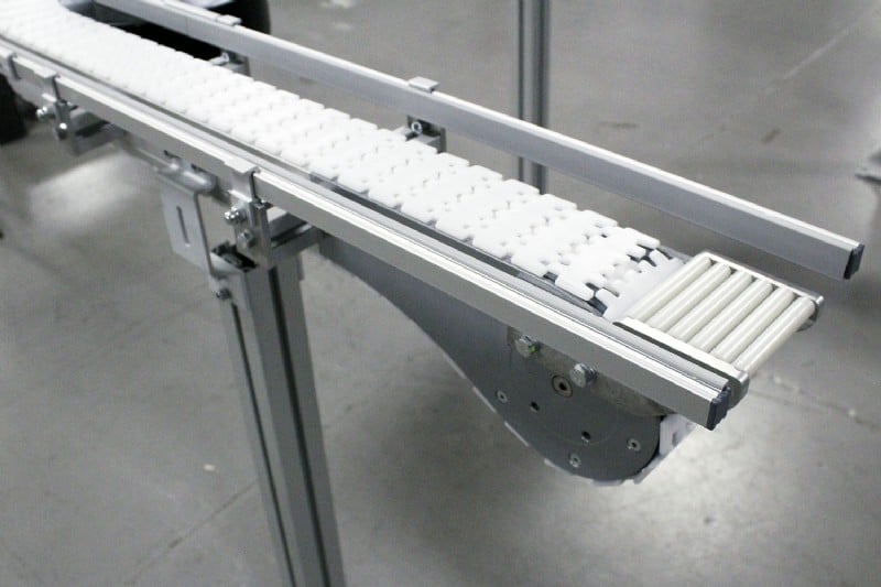 White roller transfers on a table top chain conveyor