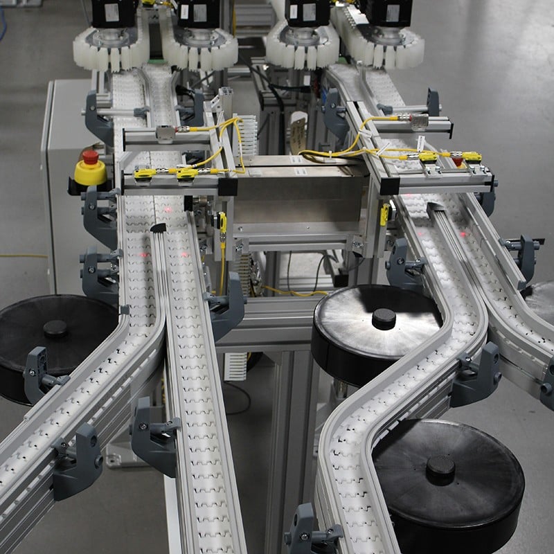 Four lanes of flexible table top chain conveyors