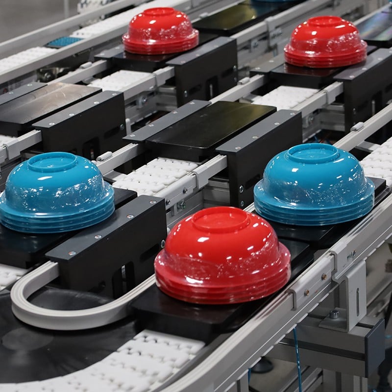 red and blue blows on pallets on conveyors