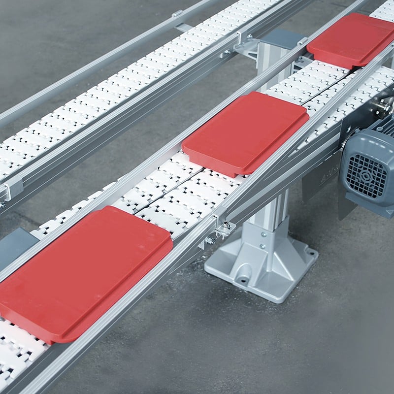 red pallets transfer between conveyors.