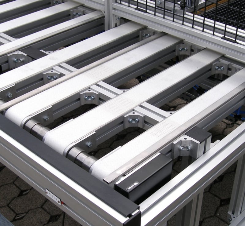 Multi-lane flat belt conveyor with white belts