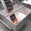 Cleated belt conveyor with hopper and orange parts