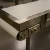 Stainless steel end stop on a stainless steel conveyor