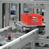 Red tote on a pallet conveyor that is rotating