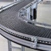 Black plastic modular belt conveyor with a curve