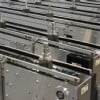 Multiple table top chain conveyors carrying parts