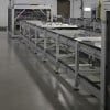 Over under conveyor system with vertical transfer units on each end