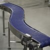 Plastic modular belt conveyor shaped like an S.