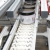 conveyor carrying lotion containers
