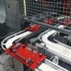 Red pallets on a flexible chain conveyor