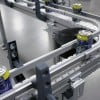Table top chain conveyor carrying cans