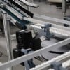 Flexible chain conveyor feeding incline belt conveyor
