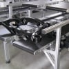 Wide multi lane conveyor carrying molded parts
