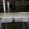 Optional rolling nose bar idler transfer Two flat belt conveyors with rolling nose bars.