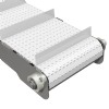 cleated plastic modular belt on a stainless steel conveyor