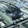Attachment chain conveyor with pallets carrying auto bumpers for assembly